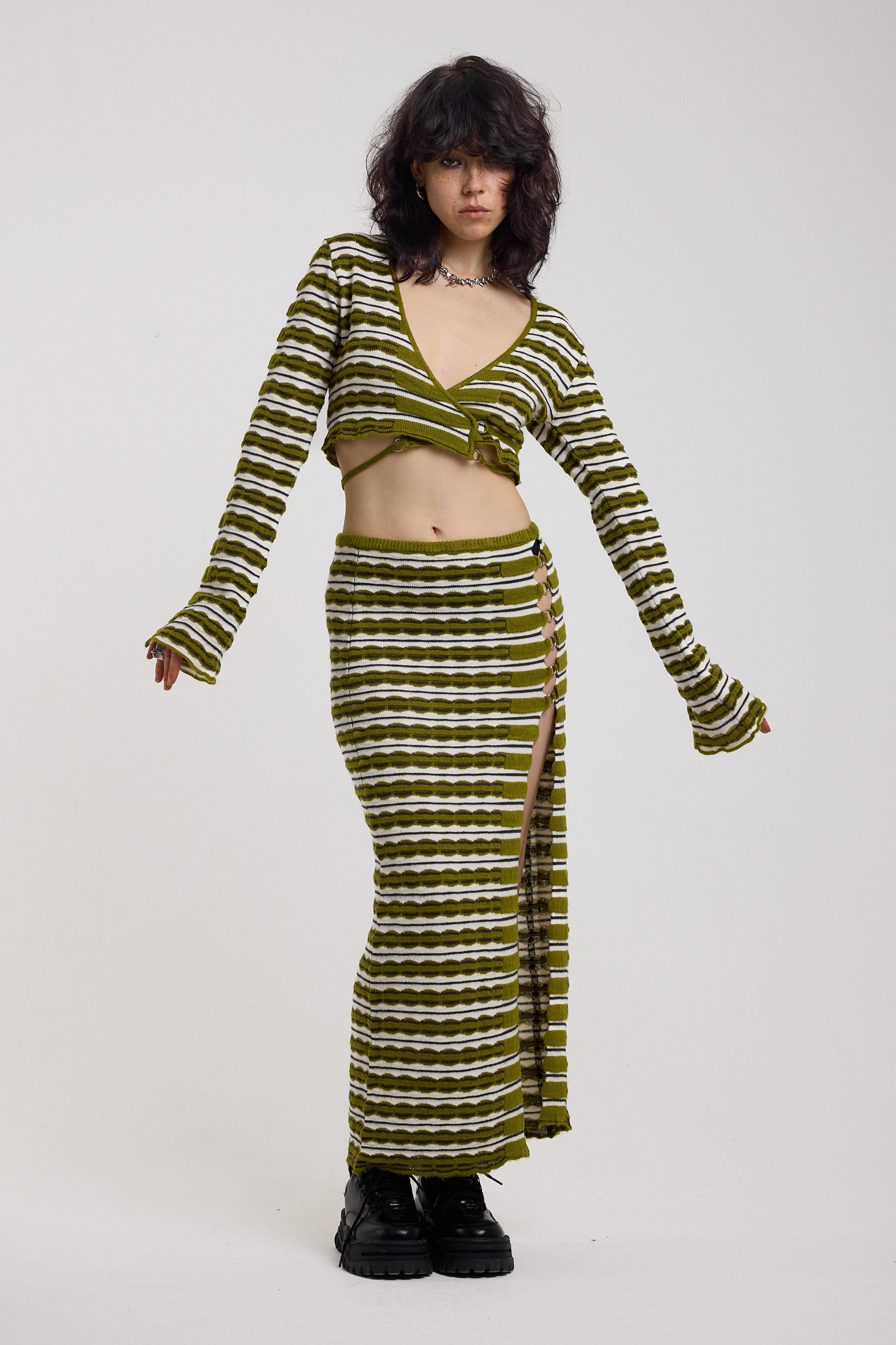 Green textured stripe knit maxi skirt with thigh high split and silver hardware detailing, worn as a co-ord by model