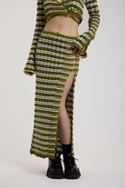 Green textured stripe knit maxi skirt with thigh high split and silver hardware detailing, worn as a co-ord by model