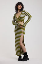 Green textured stripe knit maxi skirt with thigh high split and silver hardware detailing, worn as a co-ord by model