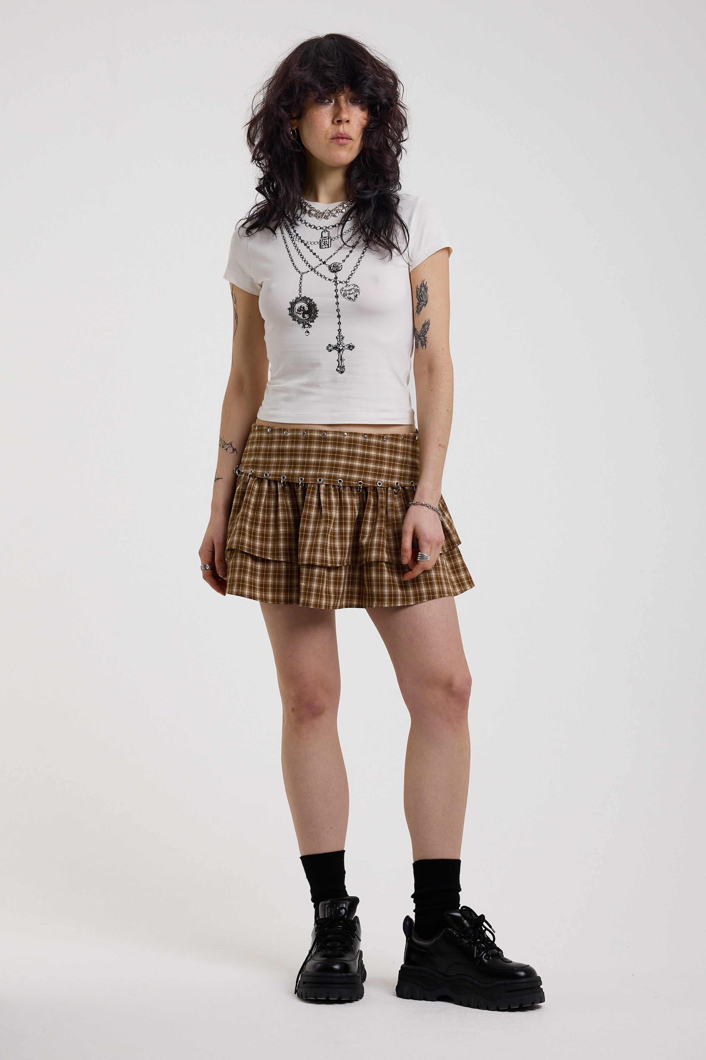 Grunge check ruffle mini skirt with silver eyelet and ring detail hardware, worn by model