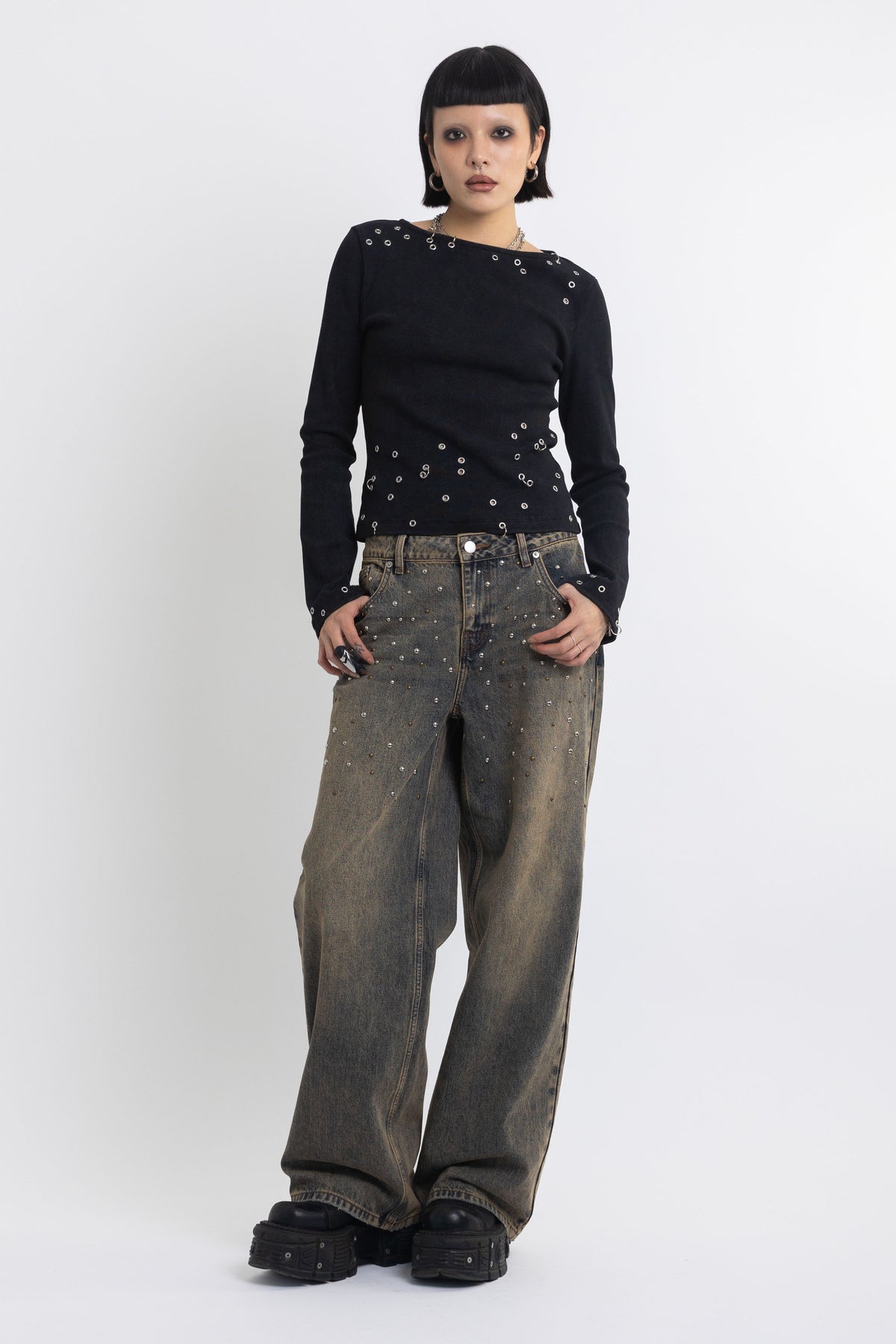 Dirty wash ultra baggy colossus jeans with scattered studs, worn by model