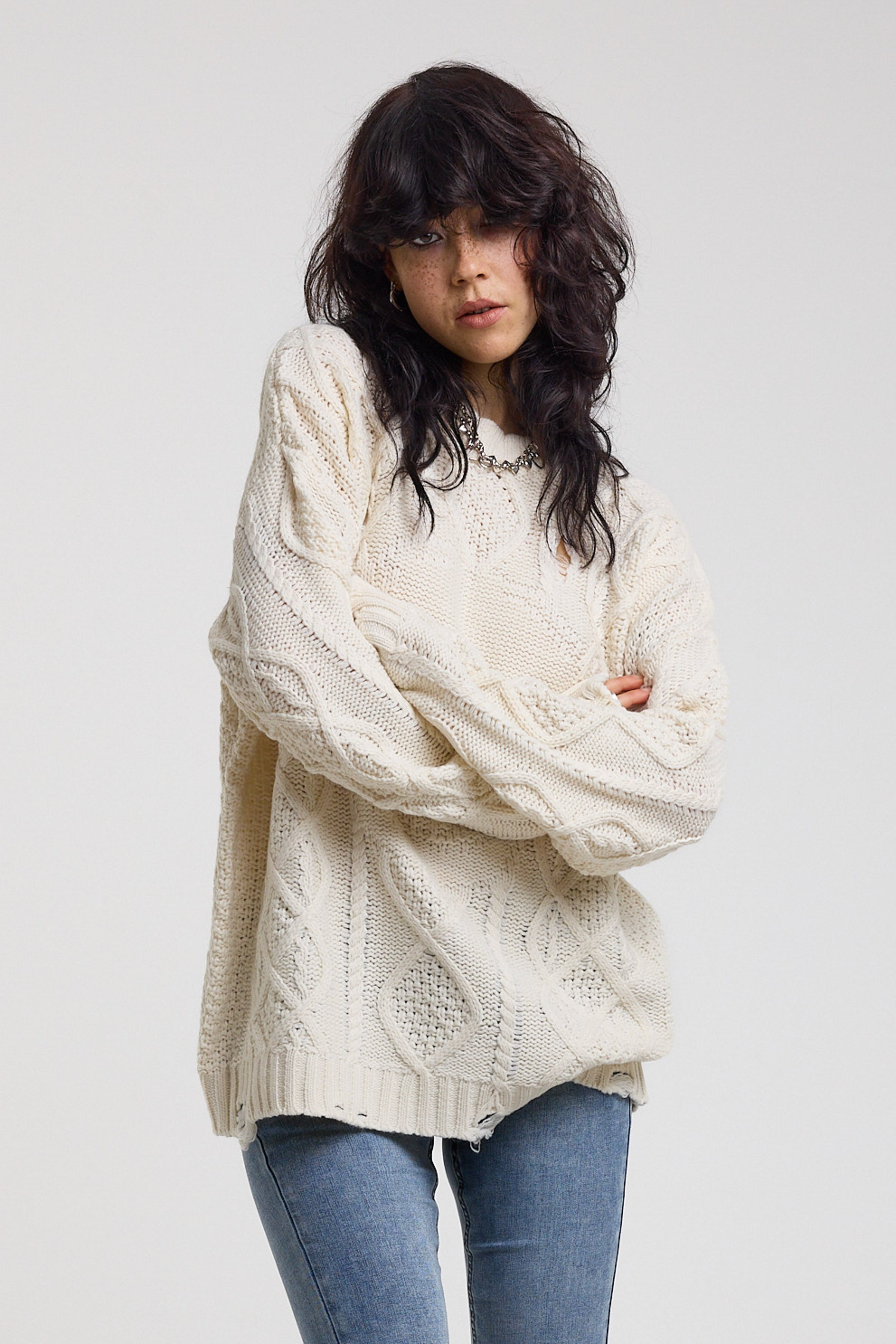 Cream oversized cable knit jumper with skull motif and distressed details, worn by model