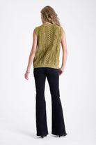 Acid wash green cable knit sweater vest, worn by model.
