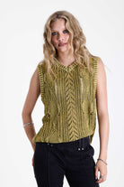 Acid wash green cable knit sweater vest, worn by model.