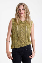 Acid wash green cable knit sweater vest, worn by model.
