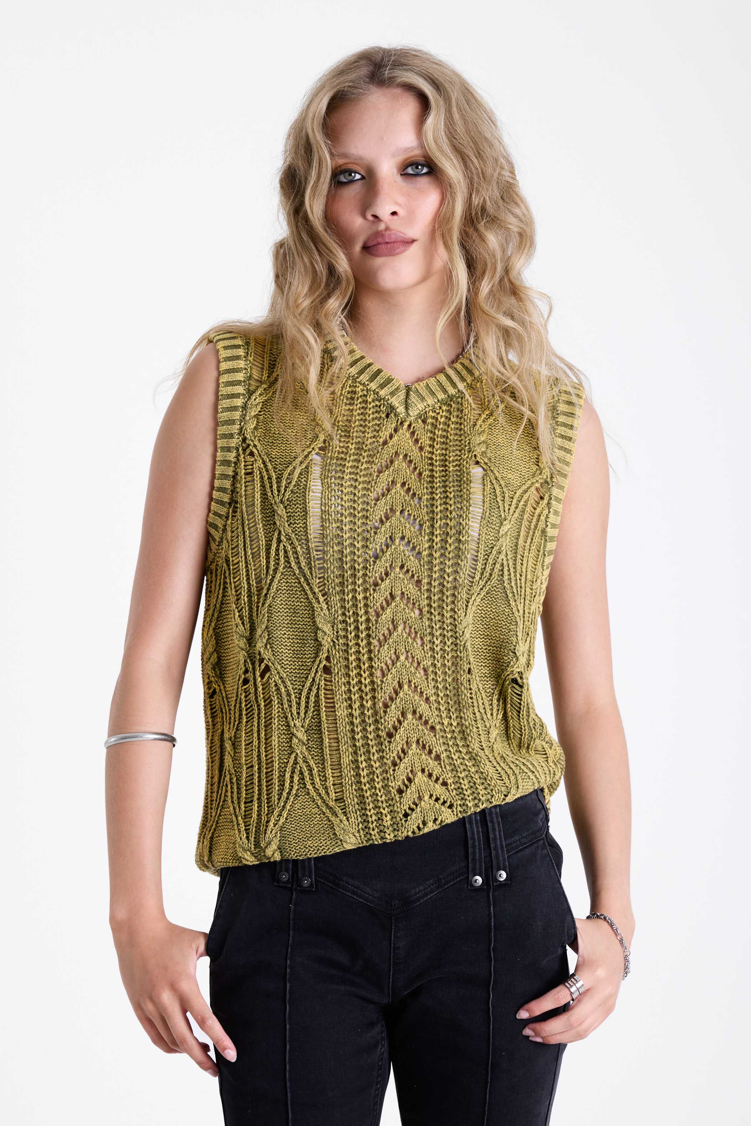 Acid wash green cable knit sweater vest, worn by model.