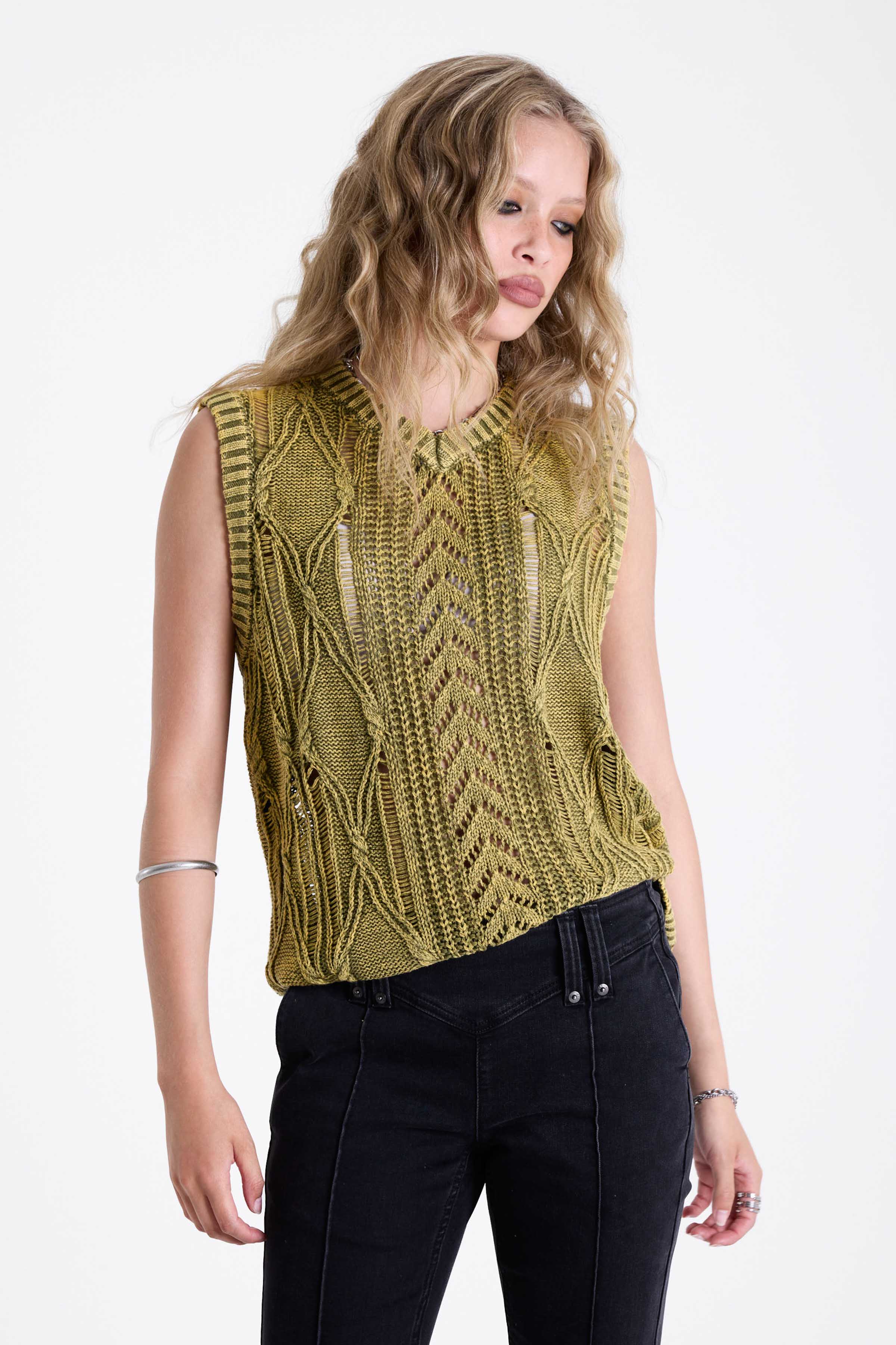 Acid wash green cable knit sweater vest, worn by model.