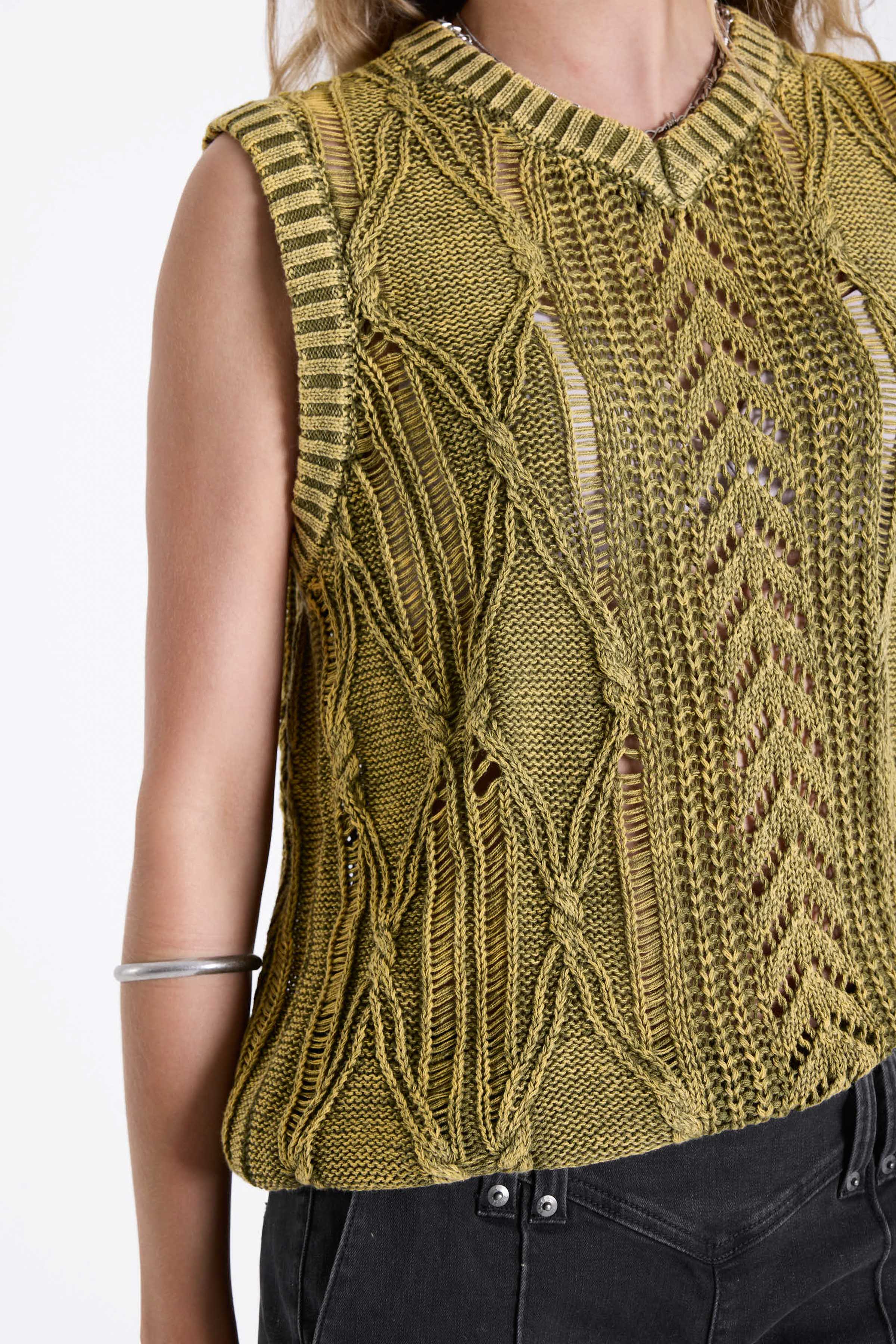 Acid wash green cable knit sweater vest, worn by model.