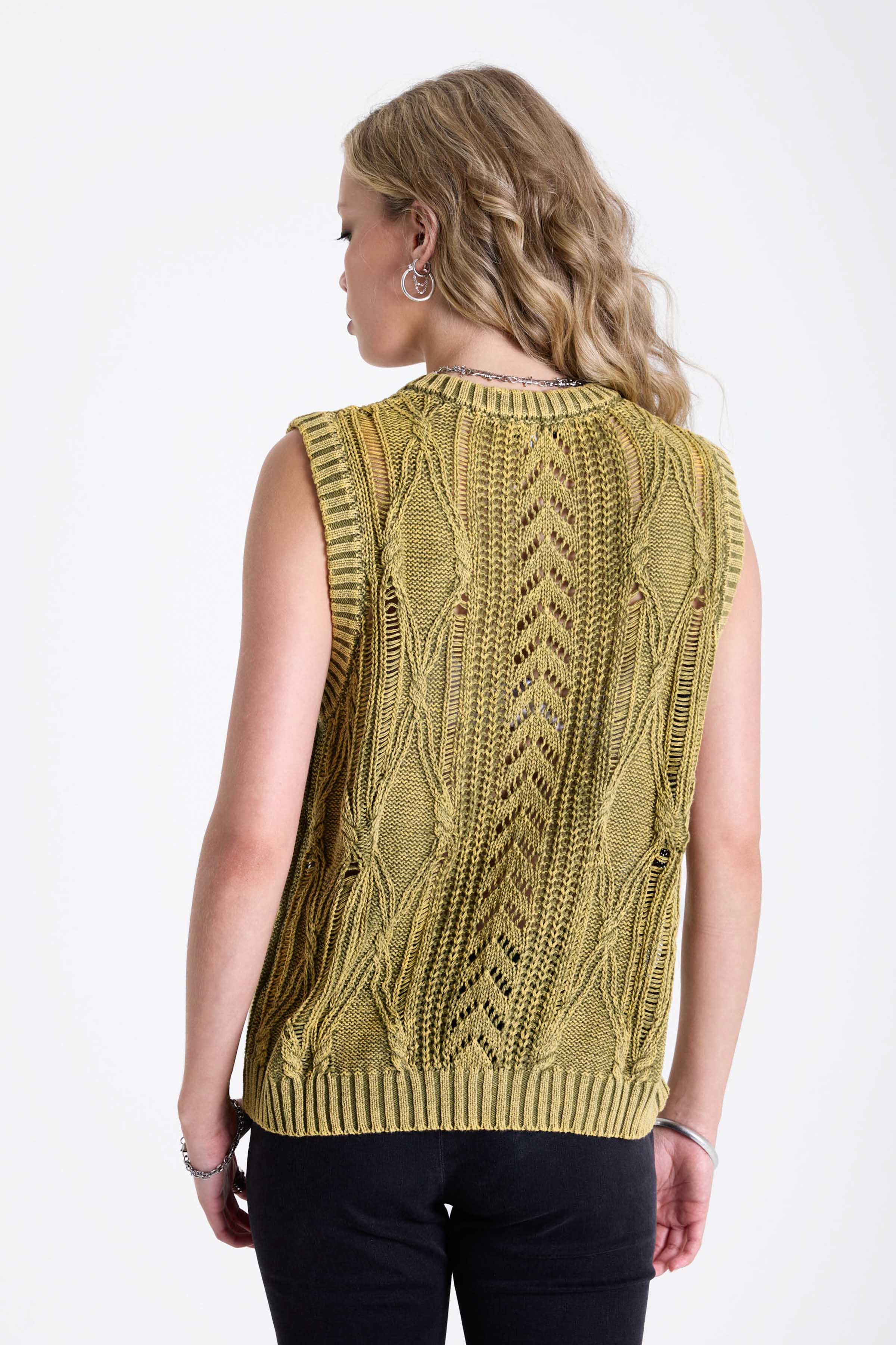 Acid wash green cable knit sweater vest, worn by model.