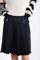 Washed denim pleated midi skirt with double eyelet crossover belt detail, worn by model