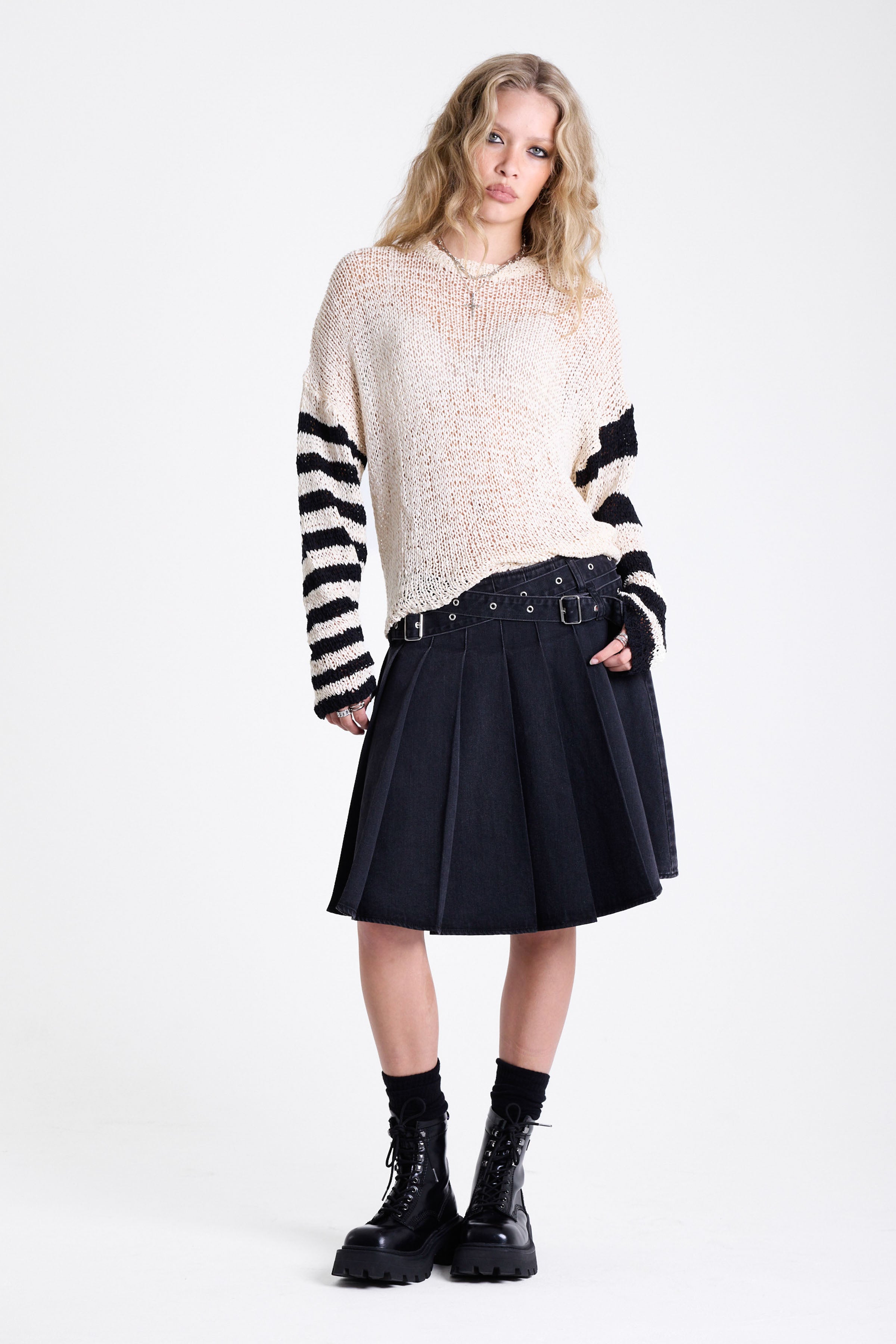 Washed denim pleated midi skirt with double eyelet crossover belt detail, worn by model