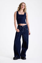 Dark rinse denim square neck corset top with contrast seam detail, worn by model.