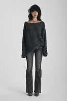 Chunky ribbed knit jumper with slash neck and O-ring cut outs, worn by model