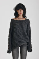 Chunky ribbed knit jumper with slash neck and O-ring cut outs, worn by model