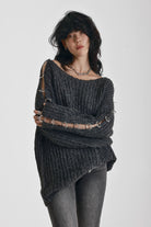 Chunky ribbed knit jumper with slash neck and O-ring cut outs, worn by model