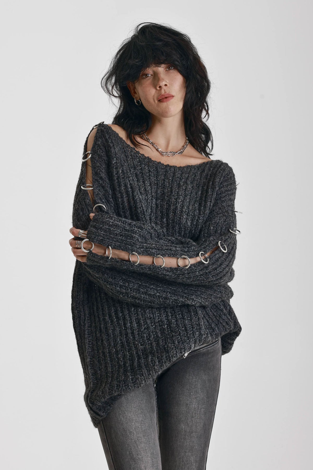 Chunky ribbed knit jumper with slash neck and O-ring cut outs, worn by model