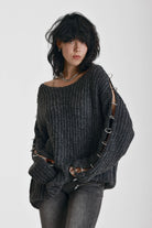 Chunky ribbed knit jumper with slash neck and O-ring cut outs, worn by model