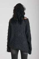 Chunky ribbed knit jumper with slash neck and O-ring cut outs, worn by model