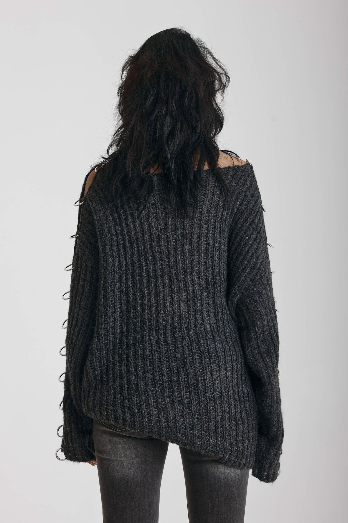 Chunky ribbed knit jumper with slash neck and O-ring cut outs, worn by model