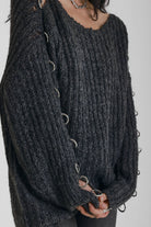 Chunky ribbed knit jumper with slash neck and O-ring cut outs, worn by model