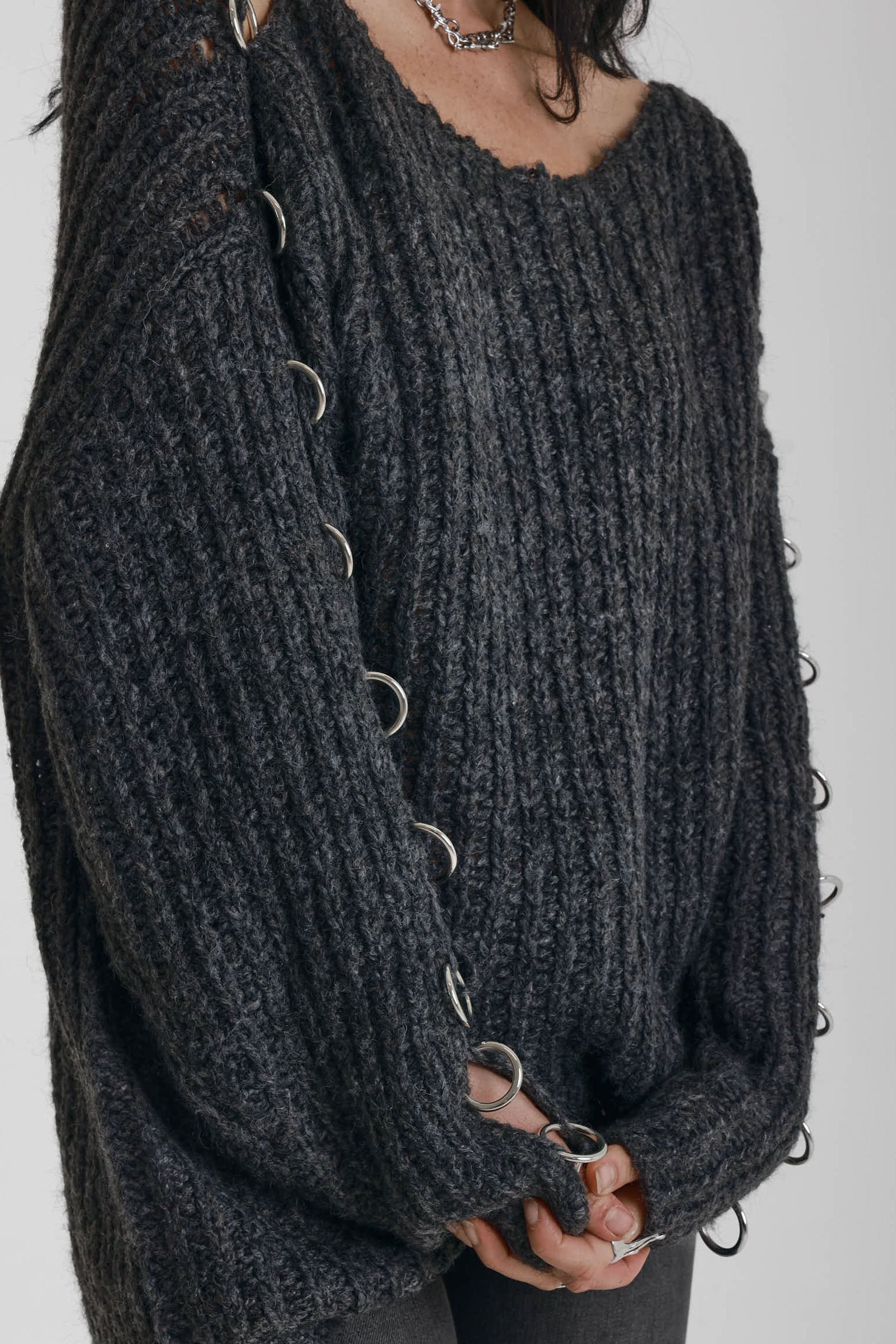 Chunky ribbed knit jumper with slash neck and O-ring cut outs, worn by model