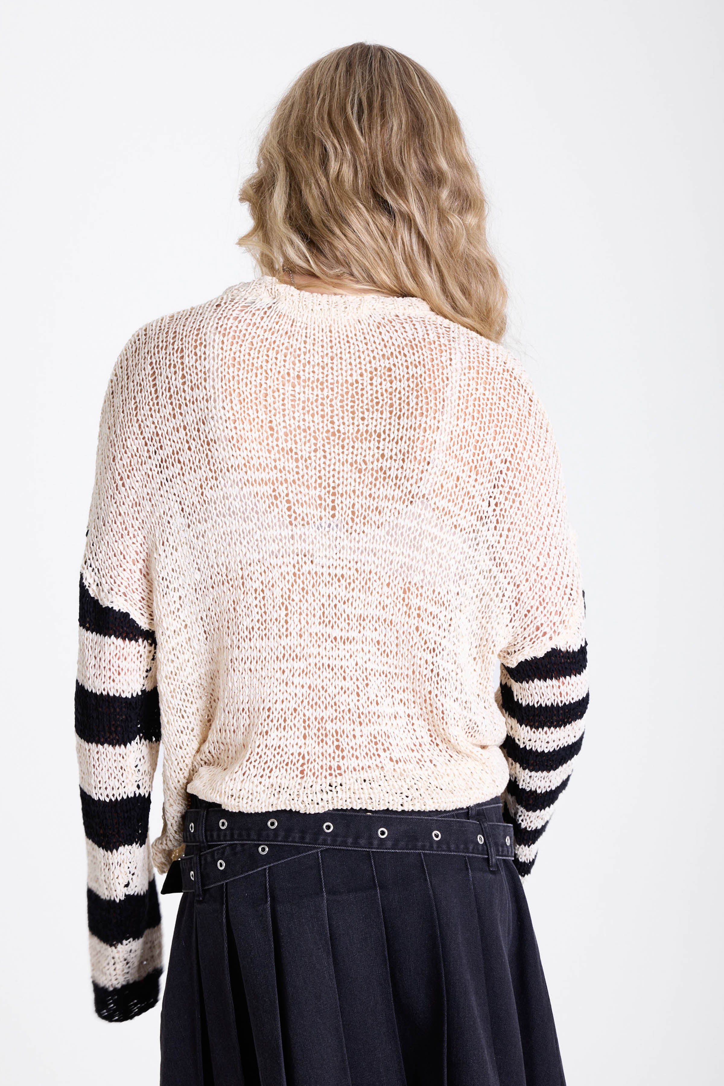 White relaxed open knit jumper with contrasting stripe sleeves, worn by model