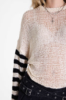 White relaxed open knit jumper with contrasting stripe sleeves, worn by model
