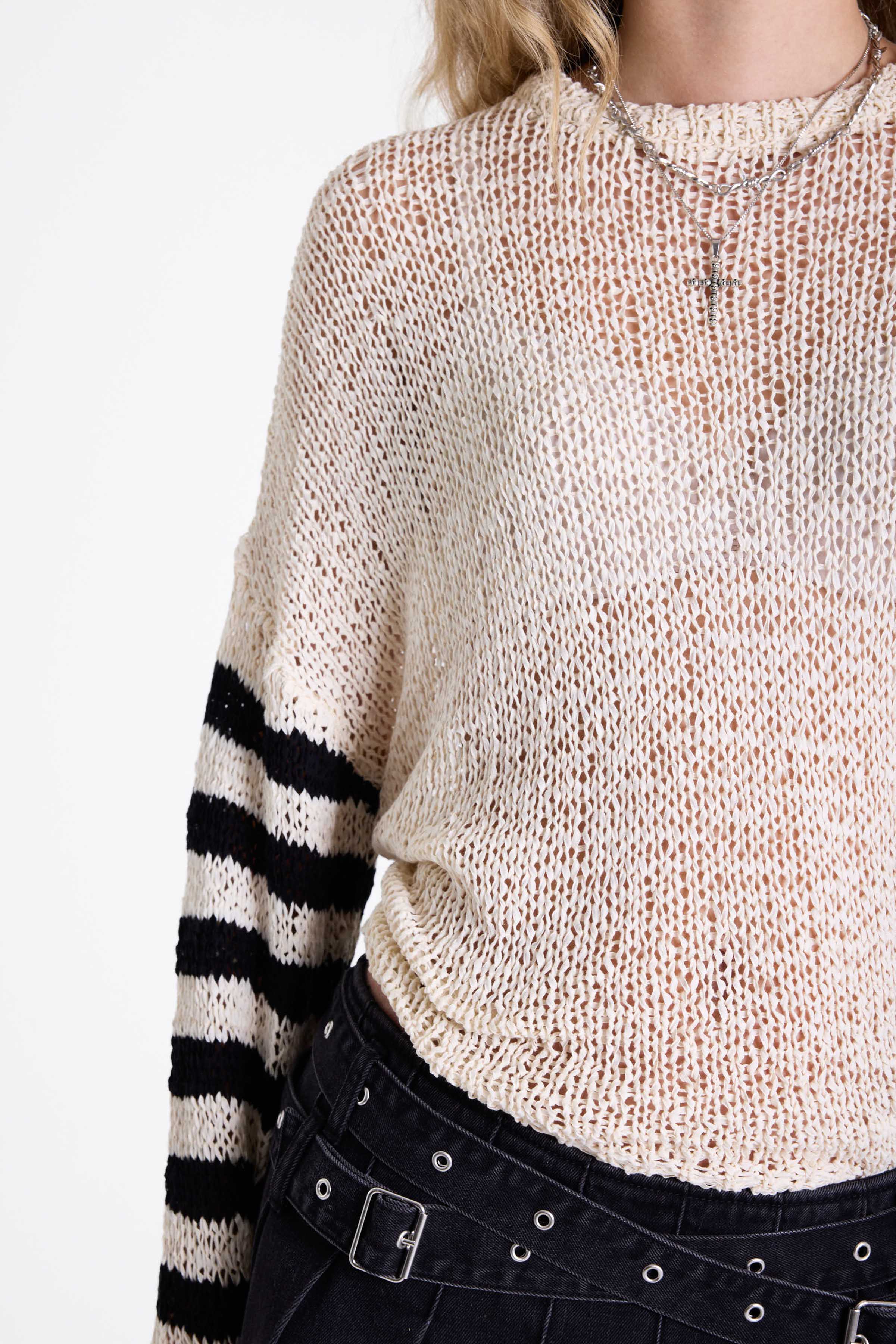 White relaxed open knit jumper with contrasting stripe sleeves, worn by model
