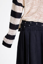 White relaxed open knit jumper with contrasting stripe sleeves, worn by model