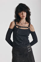 Washed black long-sleeve cold-shoulder top with cutout eyelet straps and silver buckles, worn by model