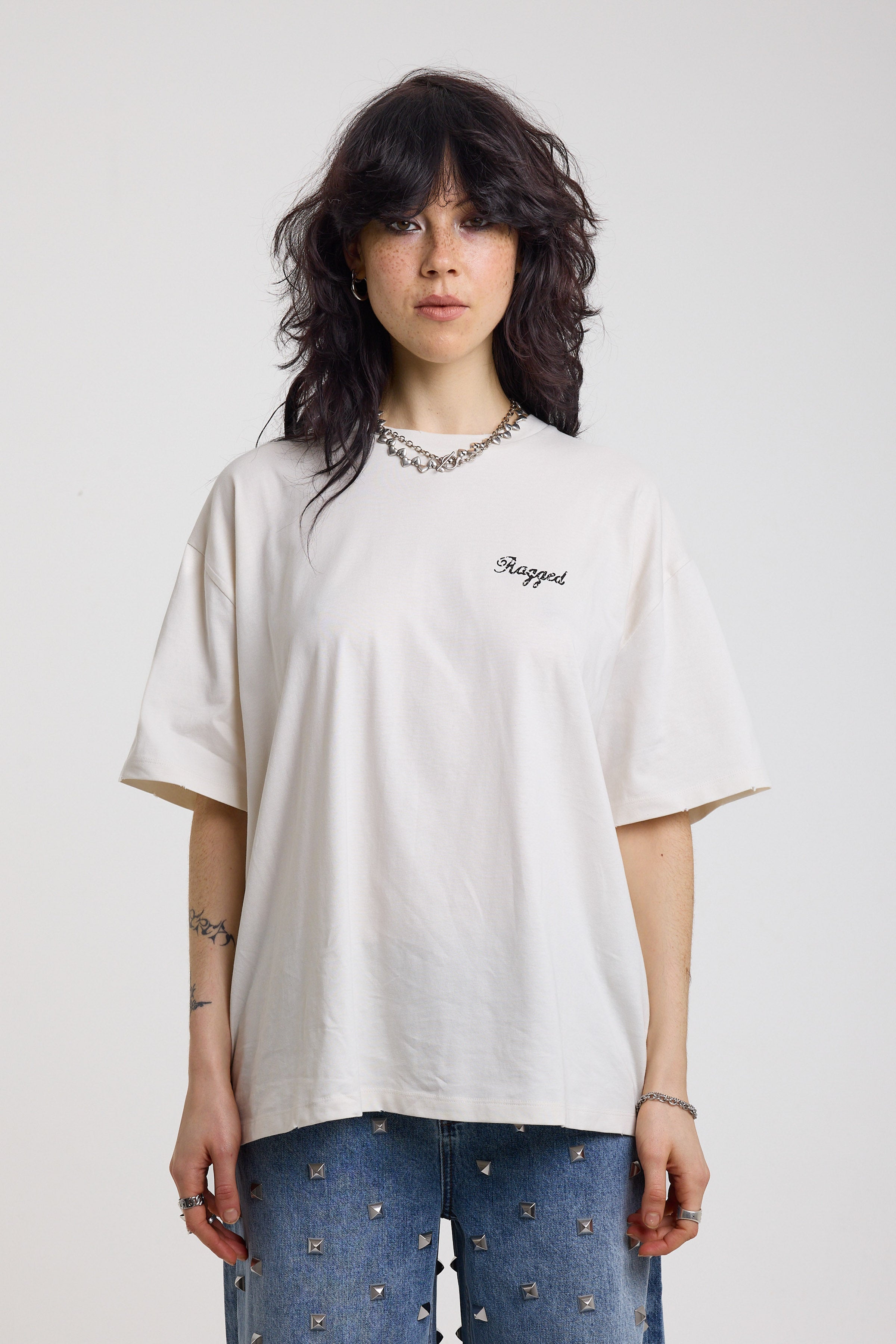 Ecru oversized t-shirt with Ragged logo, featuring a graphic heart motif on the back, worn by model