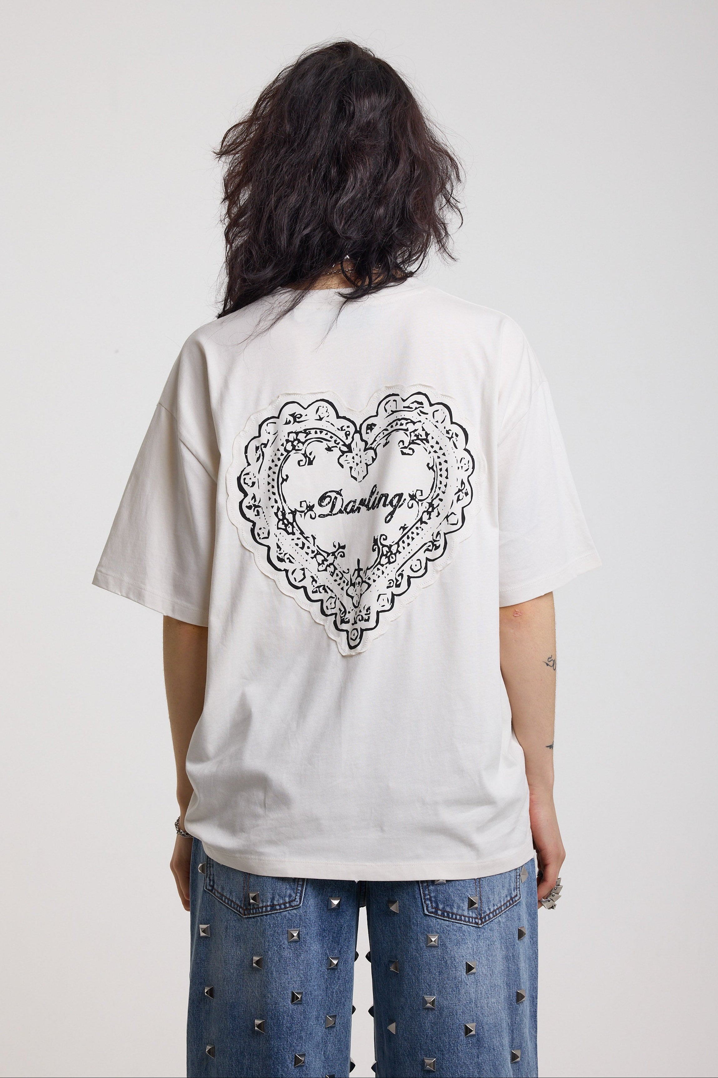 Back image showing heart motif with darling text on ecru oversized t-shirt, worn by model