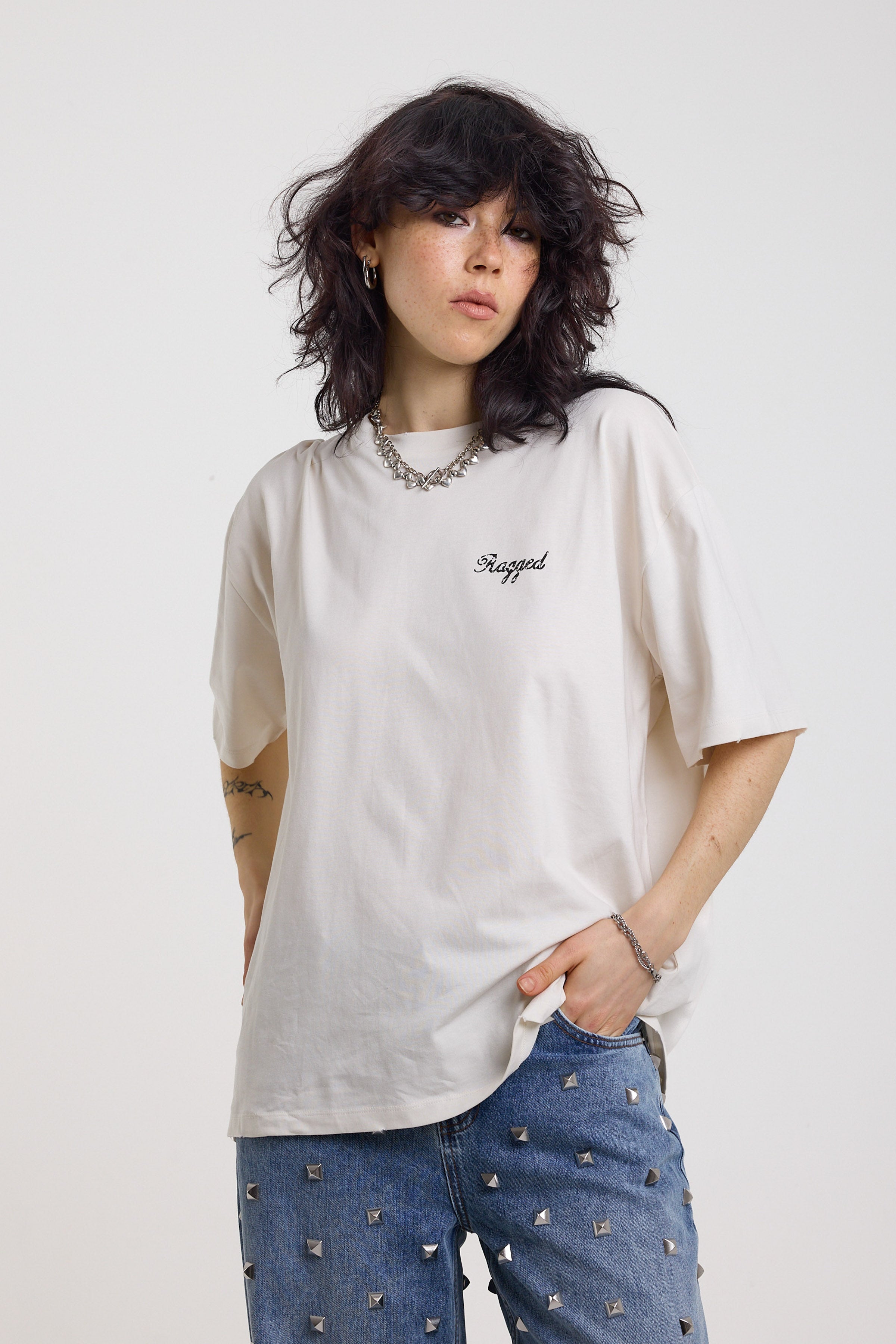 Ecru oversized t-shirt with Ragged logo, featuring a graphic heart motif on the back, worn by model