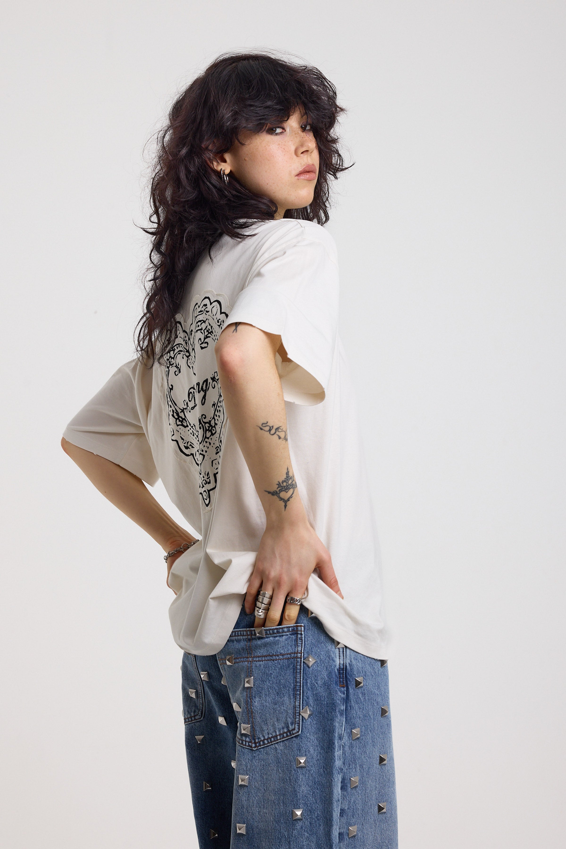 Ecru oversized t-shirt with Ragged logo, featuring a graphic heart motif on the back, worn by model