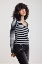 Grey and black stripe asymmetric long sleeve top with stud fastening, worn by a model