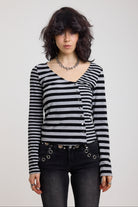 Grey and black stripe asymmetric long sleeve top with stud fastening, worn by a model