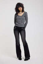 Grey and black stripe asymmetric long sleeve top with stud fastening, worn by a model