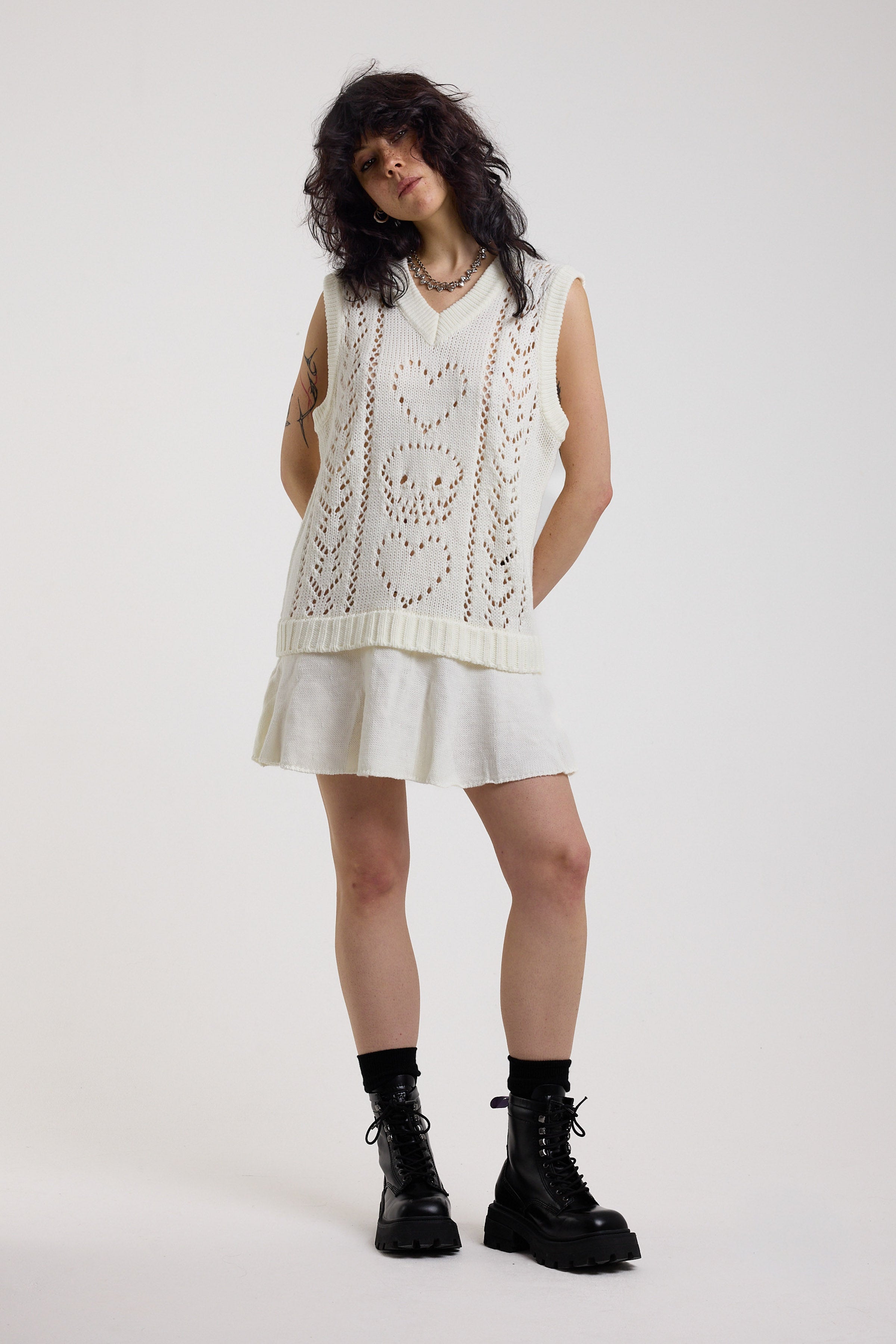 Off-white skull and heart pointelle knit mini dress with peplum hem, worn by model