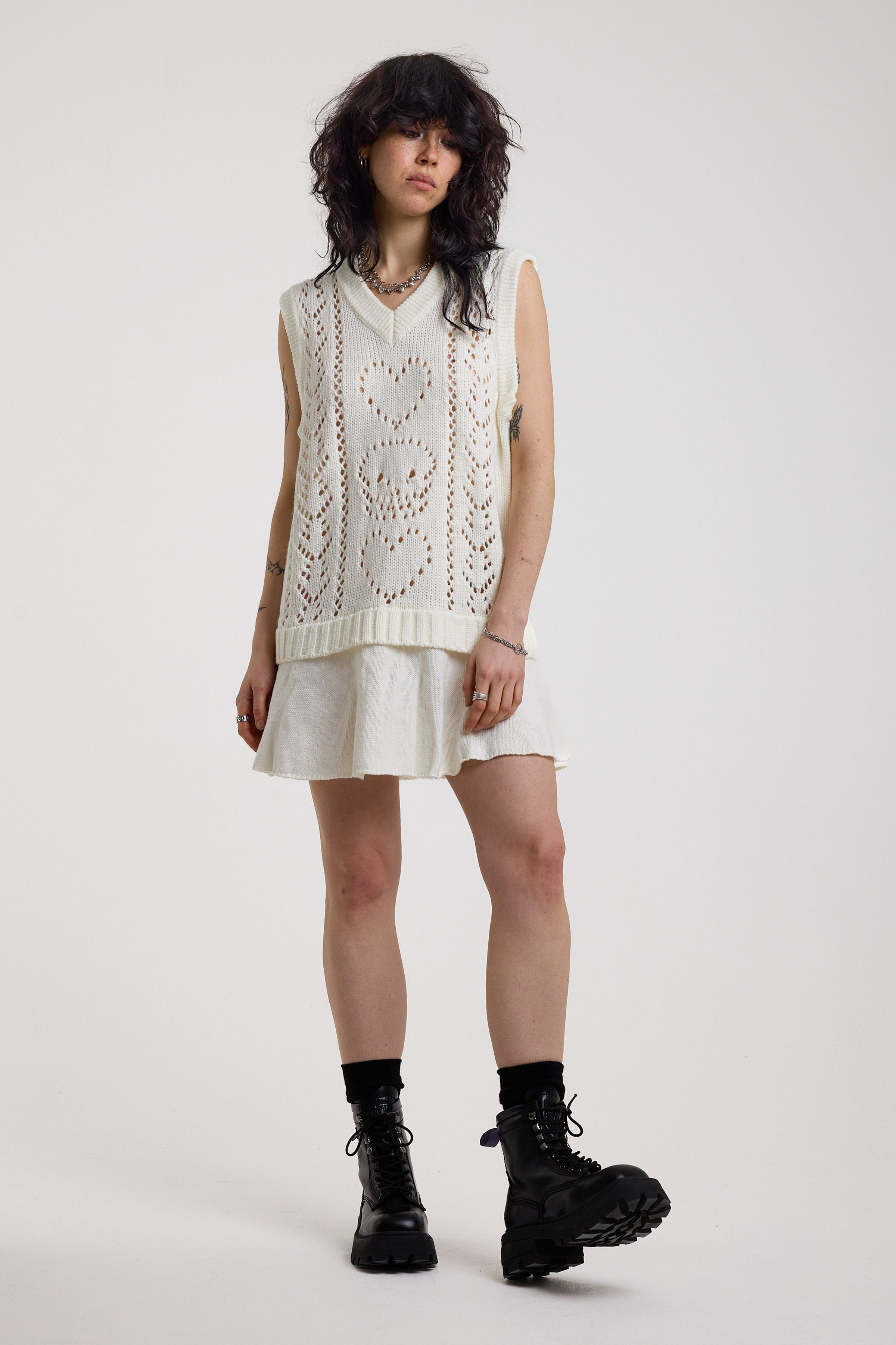 Off-white skull and heart pointelle knit mini dress with peplum hem, worn by model