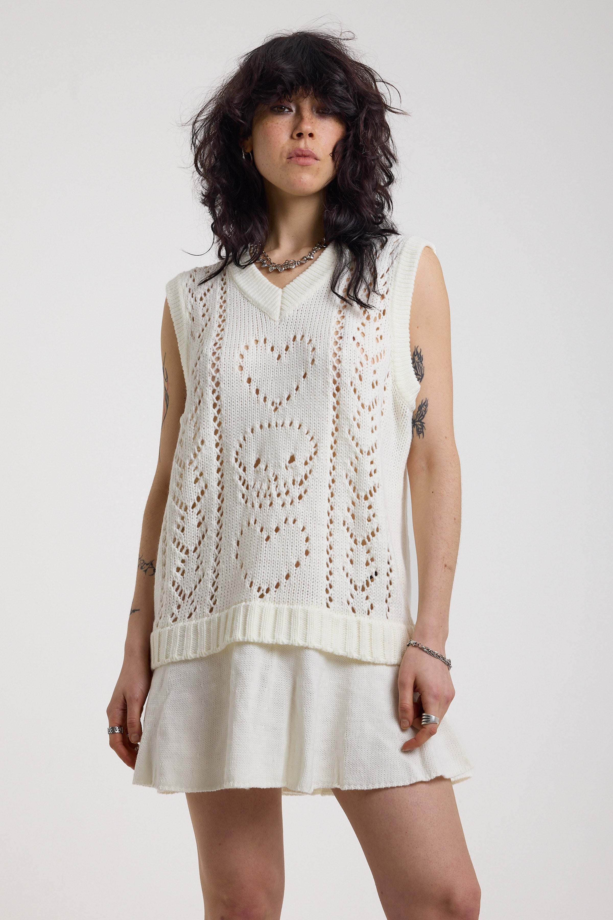 Off-white skull and heart pointelle knit mini dress with peplum hem, worn by model