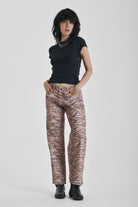 Brown tiger print relaxed straight leg jeans, worn by model