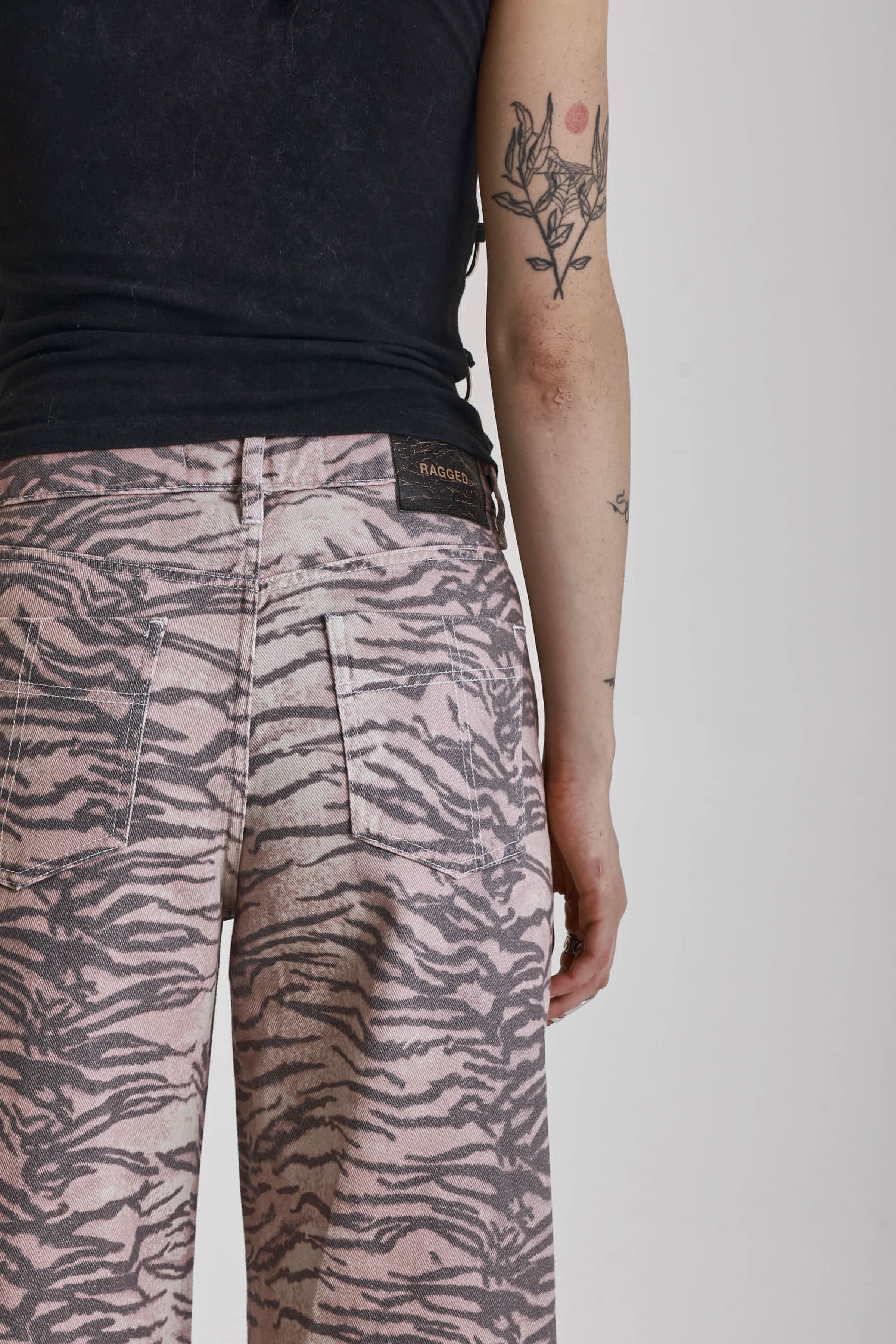 Brown tiger print relaxed straight leg jeans, worn by model