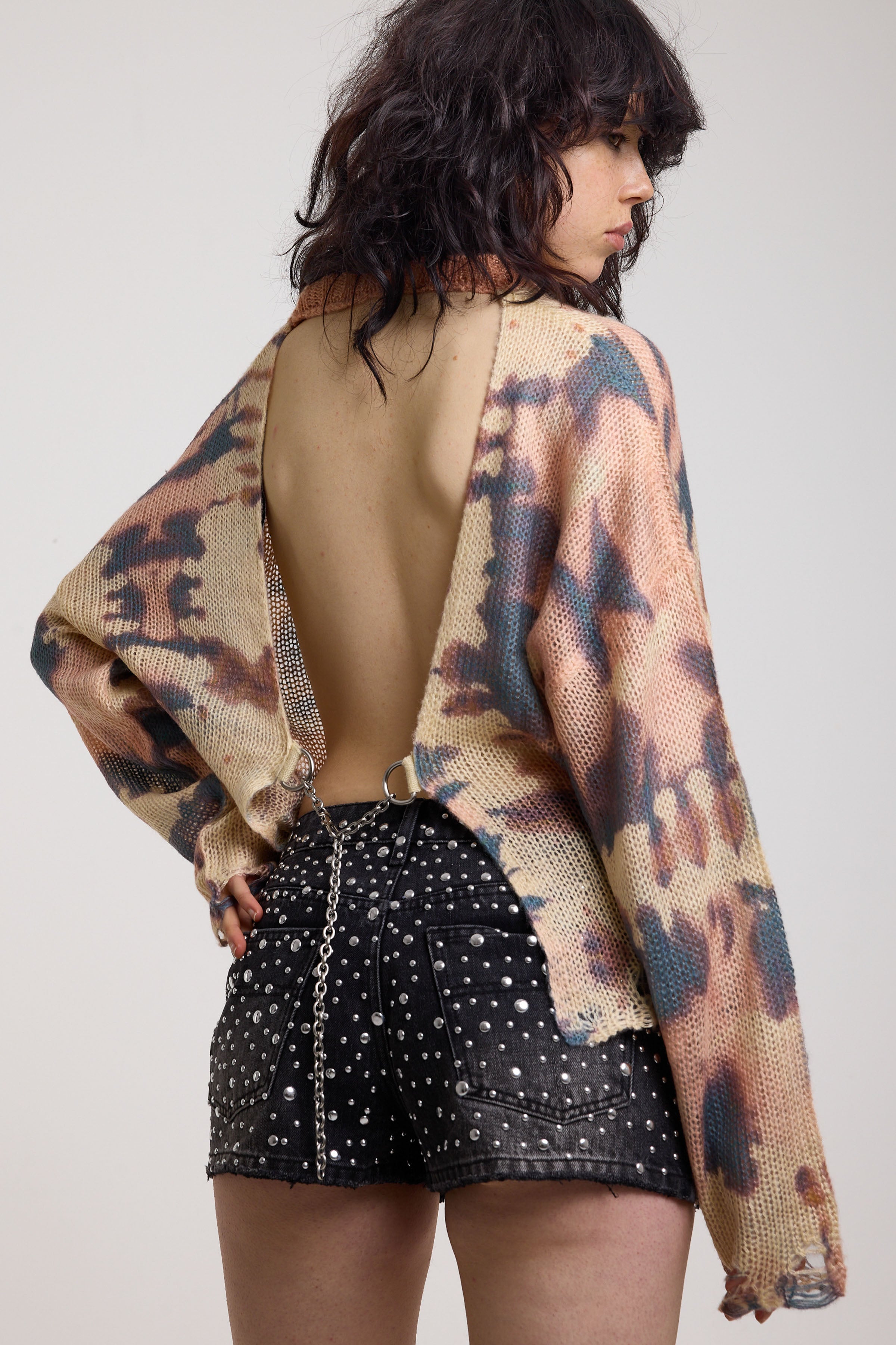 Pastel camo tie dye sheer knit jumper with open back and chain detail, worn by model