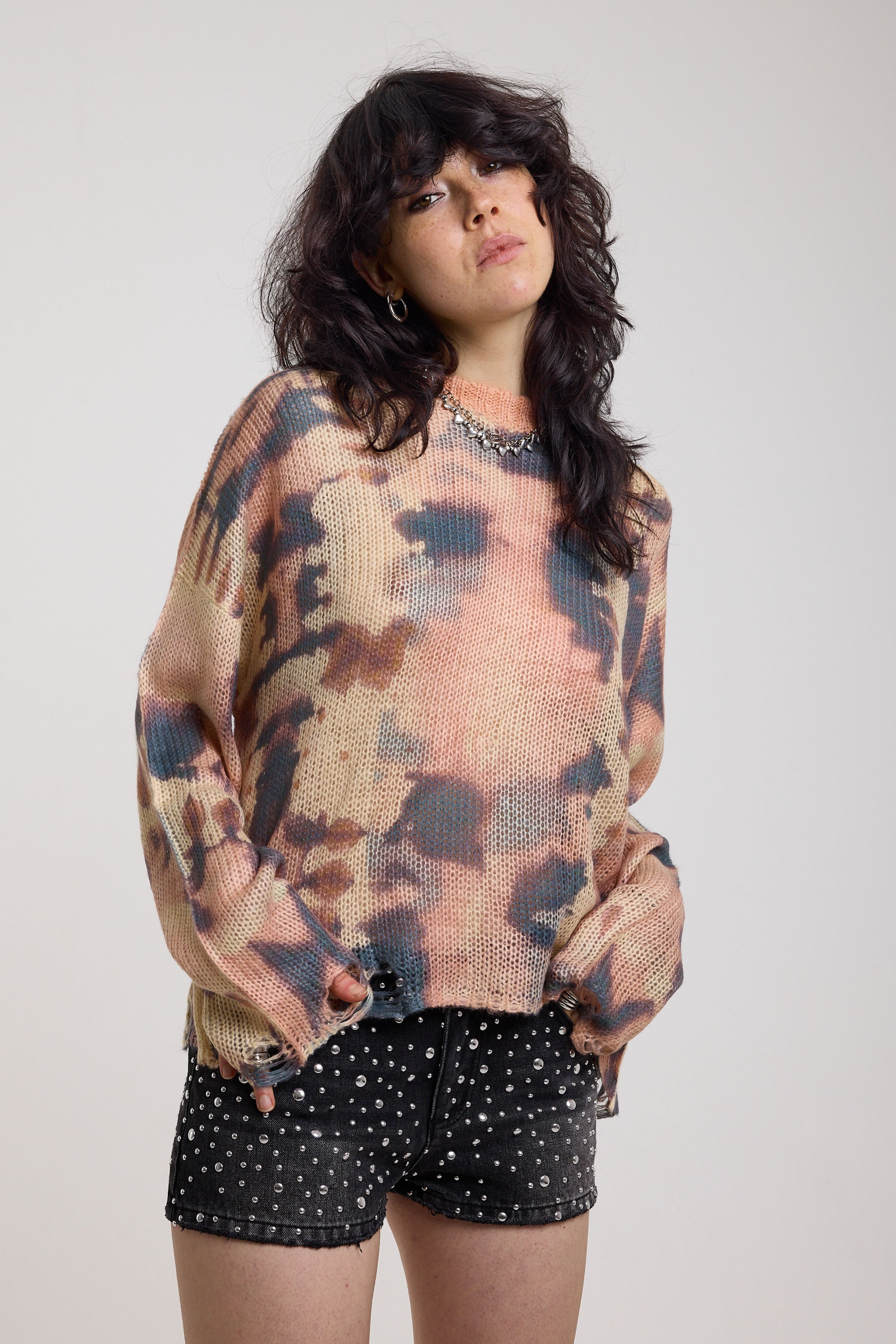Pastel camo tie dye sheer knit jumper with open back and chain detail, worn by model