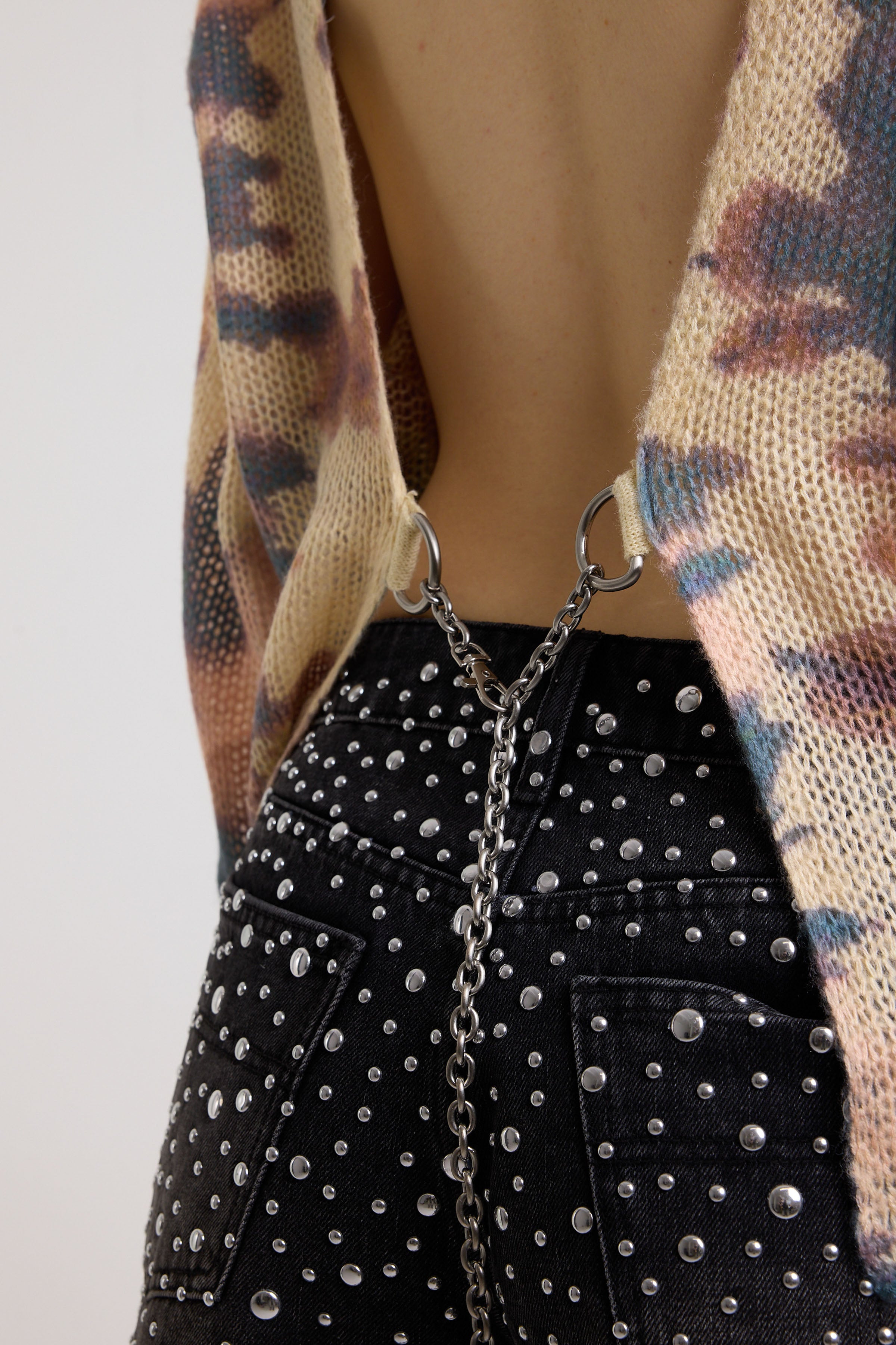 Silver chain detail and open back on pastel camo tie dye sheer knit jumper, worn by model