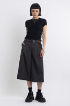 Grey pinstripe longline tailored shorts with eyelet belt and D-ring hardware, worn by model
