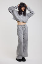 Grey cropped hoodie with silver hardware clasps worn as a tracksuit set by model