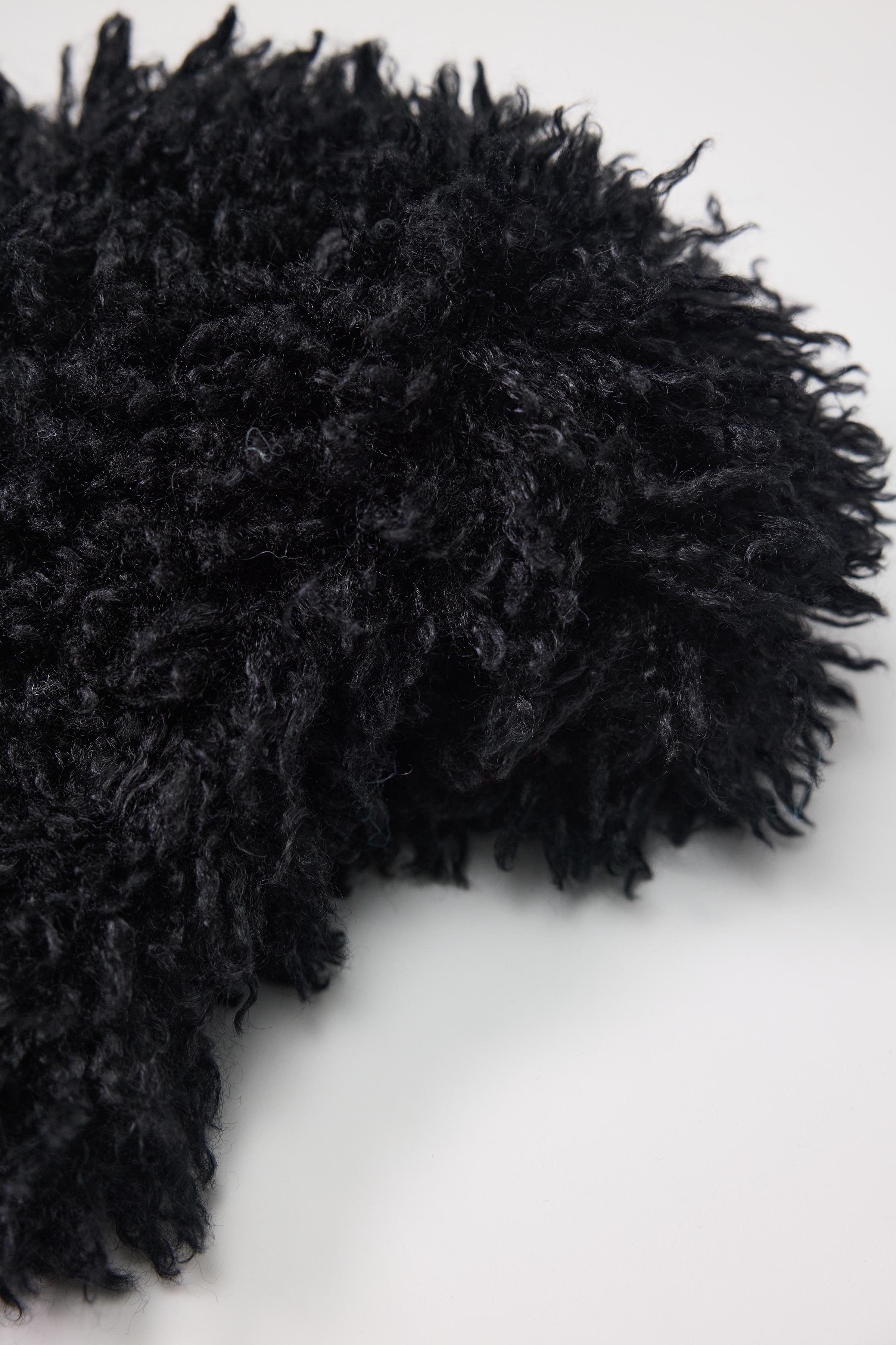 Black shaggy faux fur trapper hat with pom poms