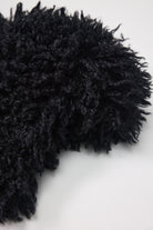 Black shaggy faux fur trapper hat with pom poms