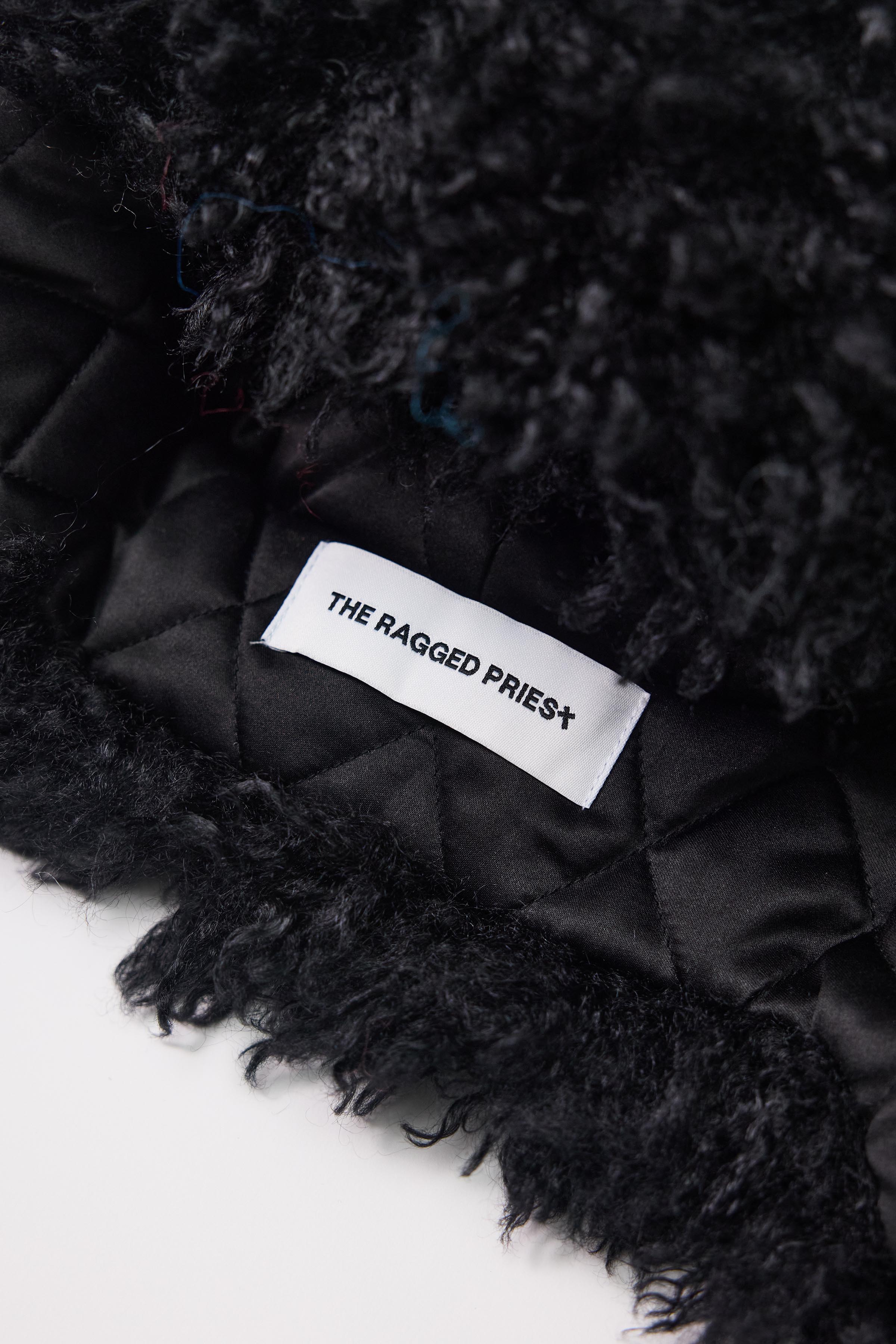 Black shaggy faux fur trapper hat with pom poms